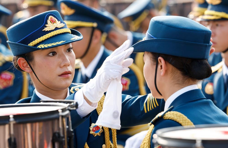 Members of the joint military band of the Chinese People's Liberation Army make preparations ahead of a grand gathering to commemorate the 80th anniversary of the victory in the Chinese People's War of Resistance against Japanese Aggression and the World Anti-Fascist War in Beijing, capital of China, Sept. 3, 2025. (Xinhua/Zhang Yuwei)