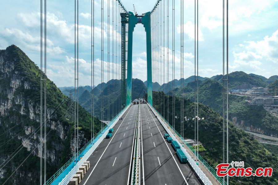 Aerial view of the Huajiang Grand Canyon Bridge, a key part of the Liuzhi to Anlong expressway, in southwest China's Guizhou Province.The 2,890-meter Huajiang Grand Canyon Bridge, which has a main span of 1,420 meters, will become the world's largest span bridge in a mountainous area. The bridge has passed crucial load-bearing tests, marking a significant milestone toward its anticipated opening in September.(Photo: Ecns.cn)