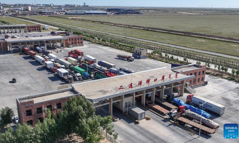 An aerial drone photo taken on Sept. 3, 2025 shows trucks waiting for border inspection at a land port in Erenhot, north China's Inner Mongolia Autonomous Region. Erenhot, the largest land port on the China-Mongolia border, is a pivotal entry-exit point for the central route of the China-Europe railway service. As of Sept. 3, inbound and outbound passenger traffic volumes and the number of vehicles driving through Erenhot reached 1.976 million and 512,000, respectively, up by 13.2 percent and 16.6 percent compared with the same period of last year. (Photo: Xinhua)