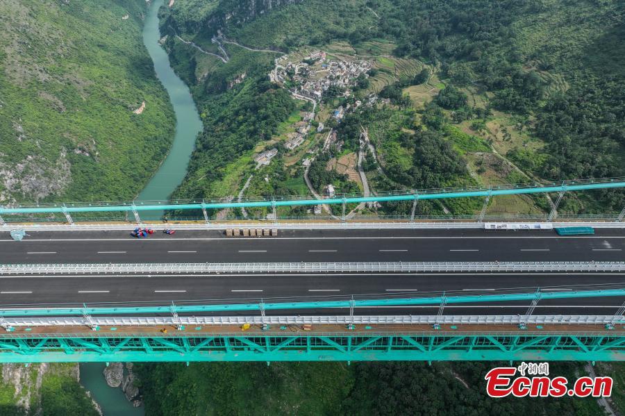 Aerial view of the Huajiang Grand Canyon Bridge, a key part of the Liuzhi to Anlong expressway, in southwest China's Guizhou Province.The 2,890-meter Huajiang Grand Canyon Bridge, which has a main span of 1,420 meters, will become the world's largest span bridge in a mountainous area. The bridge has passed crucial load-bearing tests, marking a significant milestone toward its anticipated opening in September.(Photo: Ecns.cn)
