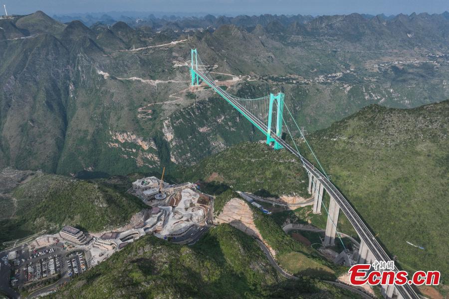 Aerial view of the Huajiang Grand Canyon Bridge, a key part of the Liuzhi to Anlong expressway, in southwest China's Guizhou Province.The 2,890-meter Huajiang Grand Canyon Bridge, which has a main span of 1,420 meters, will become the world's largest span bridge in a mountainous area. The bridge has passed crucial load-bearing tests, marking a significant milestone toward its anticipated opening in September.(Photo: Ecns.cn)