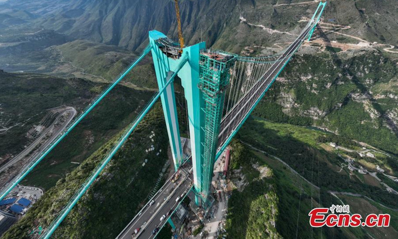 Aerial view of the Huajiang Grand Canyon Bridge, a key part of the Liuzhi to Anlong expressway, in southwest China's Guizhou Province.The 2,890-meter Huajiang Grand Canyon Bridge, which has a main span of 1,420 meters, will become the world's largest span bridge in a mountainous area. The bridge has passed crucial load-bearing tests, marking a significant milestone toward its anticipated opening in September.(Photo: Ecns.cn)