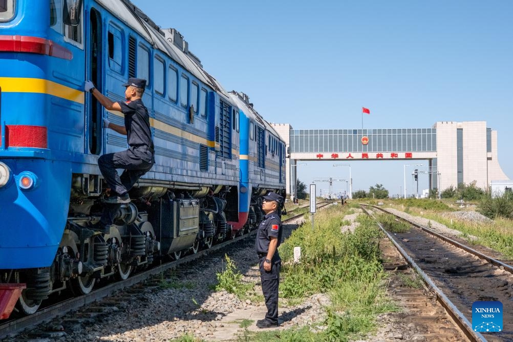 Immigration officers inspect a China-Europe freight train at a rail port in Erenhot, north China's Inner Mongolia Autonomous Region, Sept. 3, 2025. Erenhot, the largest land port on the China-Mongolia border, is a pivotal entry-exit point for the central route of the China-Europe railway service. As of Sept. 3, inbound and outbound passenger traffic volumes and the number of vehicles driving through Erenhot reached 1.976 million and 512,000, respectively, up by 13.2 percent and 16.6 percent compared with the same period of last year. (Photo: Xinhua)
