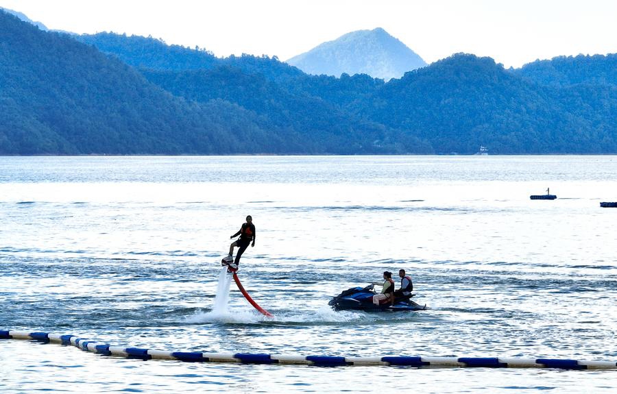 Visitors enjoy water activities at a water sports center in Huangshan City, east China's Anhui Province, Aug. 28, 2025. During the summer vacation, cities across Anhui Province have leveraged their abundant mountain and water resources to develop a cool economy, attracting large numbers of visitors. (Photo: Xinhua)