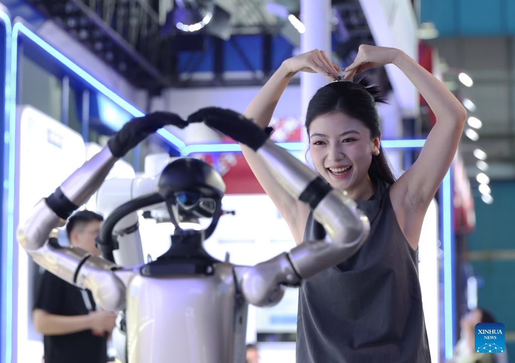 A visitor interacts with a robot at the exhibition area of the 2025 Global Industrial Internet Conference in Shenyang, northeast China's Liaoning Province, Sept. 6, 2025. Themed Digital New Chapter, Intelligent New Quality, the 2025 Global Industrial Internet Conference kicked off here on Saturday and will last till Sept. 8. (Photo: Xinhua)