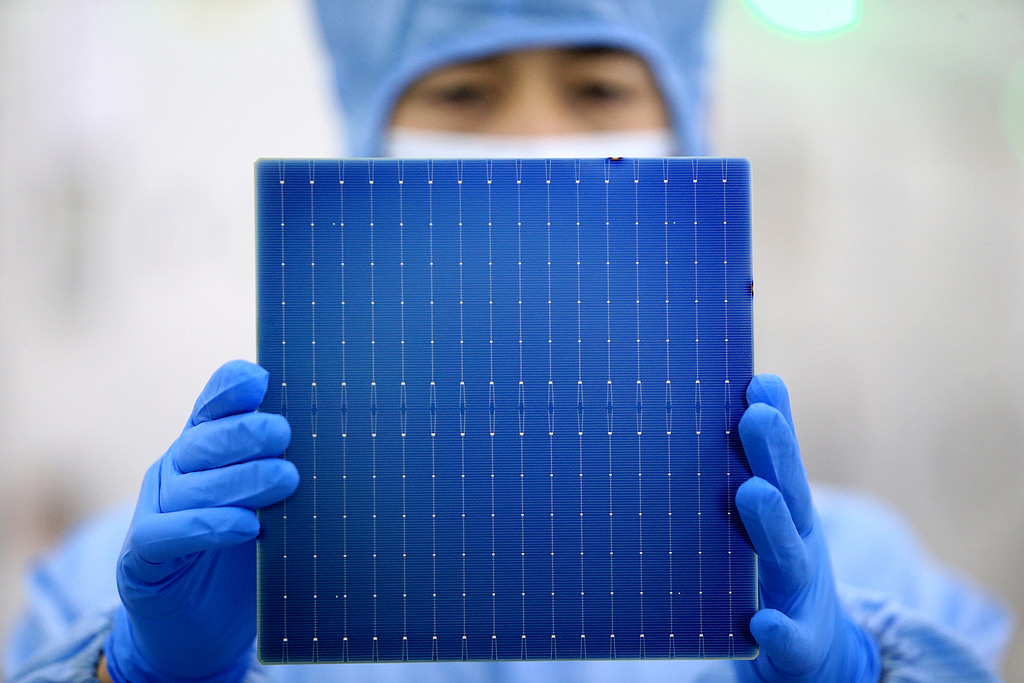 A worker checks a component for solar panels in the smart workshop of a photovoltaic solar panel manufacturing company in the Yizheng Economic Development Zone, East China's Jiangsu Province, on September 11, 2025. Solar panel manufacturers are running at full capacity to meet surging orders and are making a concerted push to drive third-quarter sales. Photo: VCG