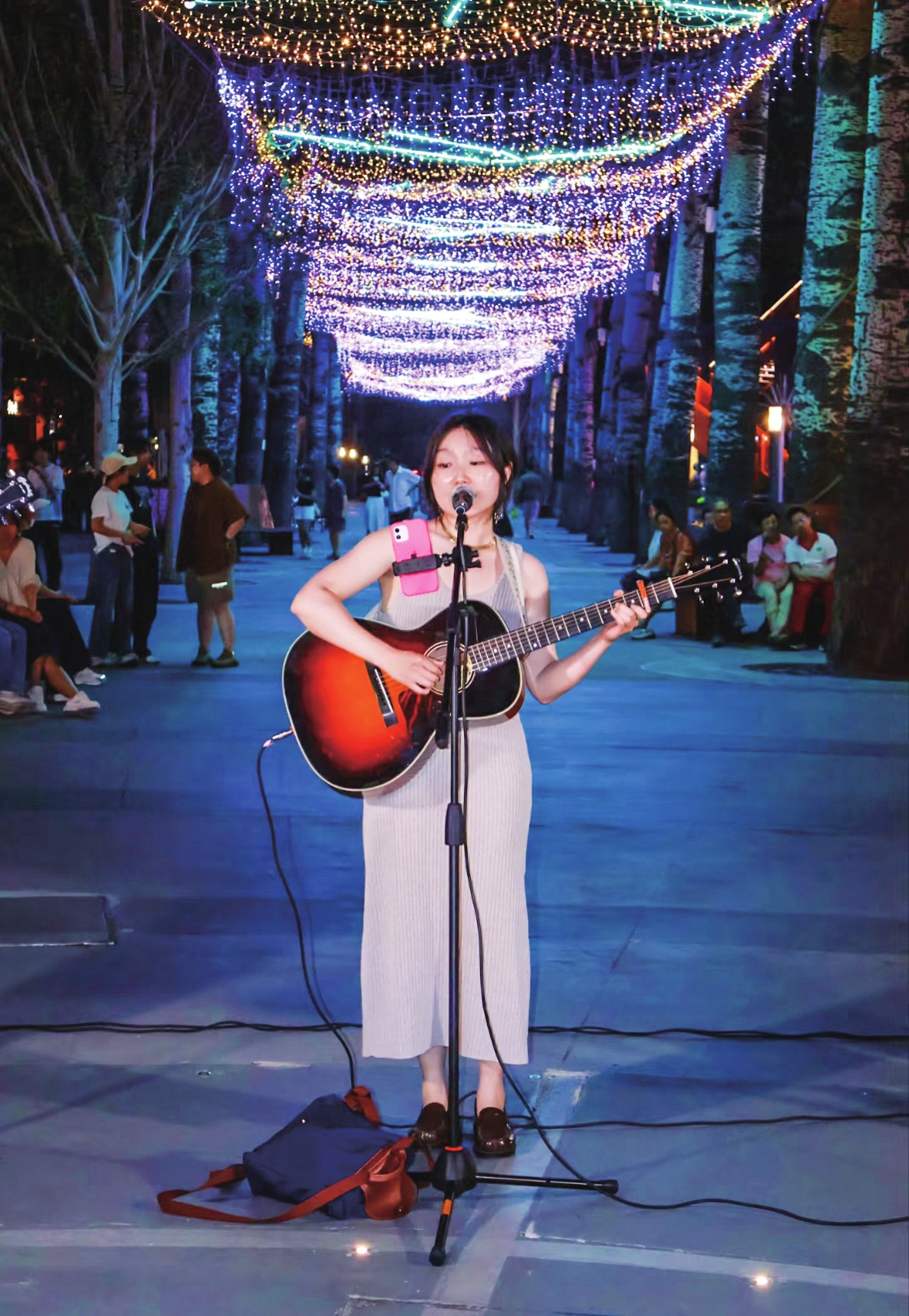 An amateur singer gives a street performance.