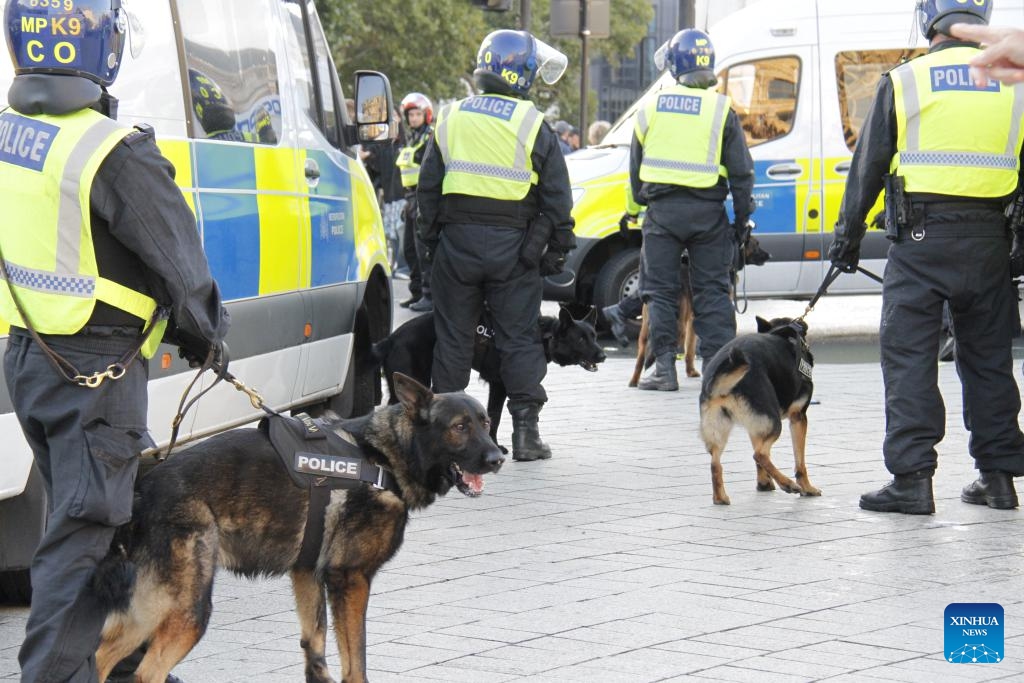 Police officers and police dogs are on duty in London, Britain, on Sept. 13, 2025. More than 100,000 protesters have joined an anti-immigration rally organized by a far-right activist on Saturday in central London. The Unite the Kingdom rally, organized by far-right activist Stephen Yaxley-Lennon, known as Tommy Robinson, led to substantial police presence and violent clashes in between protesters and between protesters and police. Multiple arrests were witnessed on-site. (Photo: Xinhua)