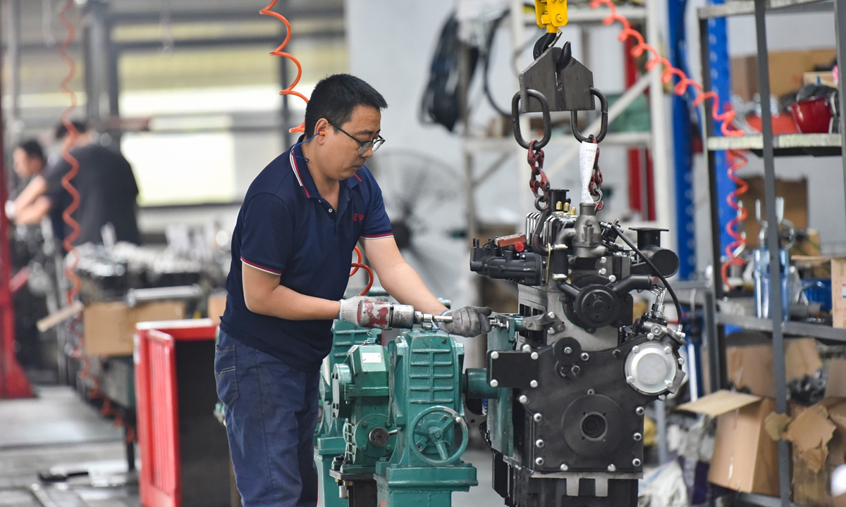 A worker assembles an engine at a machinery manufacturing enterprise in Qingzhou, East China's Shandong Province, on September 15, 2025. China's industrial added-value for companies above the designated size increased by 5.2 percent year-on-year in August, official data showed. Photo: VCG