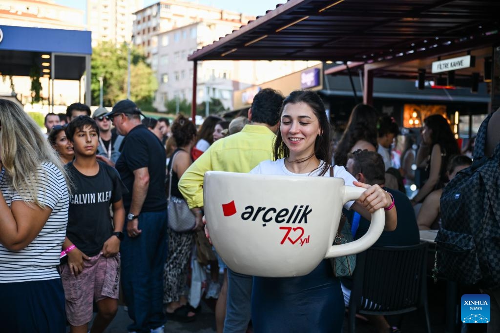 A visitor poses with a coffee cup prop at the Istanbul Coffee Festival in Istanbul, Türkiye, Sept. 13, 2025. Istanbul, Türkiye's largest city, is hosting a coffee festival from Sept. 11 to 14, where vendors from multiple countries offer attendees free tastings of hundreds of coffee varieties. (Photo: Xinhua)