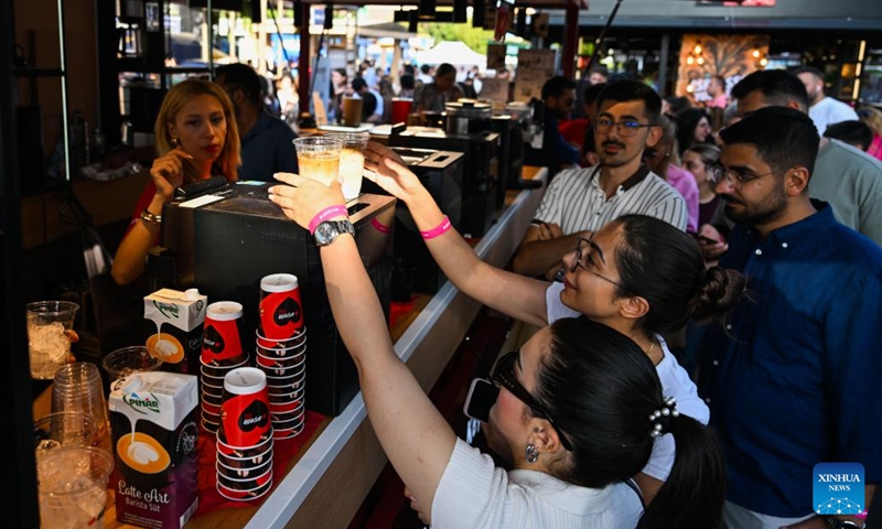 Visitors line up to receive coffee at a booth during the Istanbul Coffee Festival in Türkiye, Sept. 13, 2025. Istanbul, Türkiye's largest city, is hosting a coffee festival from Sept. 11 to 14, where vendors from multiple countries offer attendees free tastings of hundreds of coffee varieties. (Photo: Xinhua)