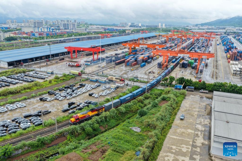 An aerial drone photo taken on Sept. 13, 2025 shows a freight train bound for Central Asia loaded with auto parts, laptops and other goods departing from Tuanjiecun Station in Chongqing, southwest China. In the first eight months of this year, 35 freight trains have been dispatched from Chongqing to Central Asia, with a container volume of more than 3,000 TEUs and a total value of nearly 600 million yuan (about 84.2 million U.S. dollars), according to statistics from the Chongqing Railway Logistics Center. (Photo: Xinhua)