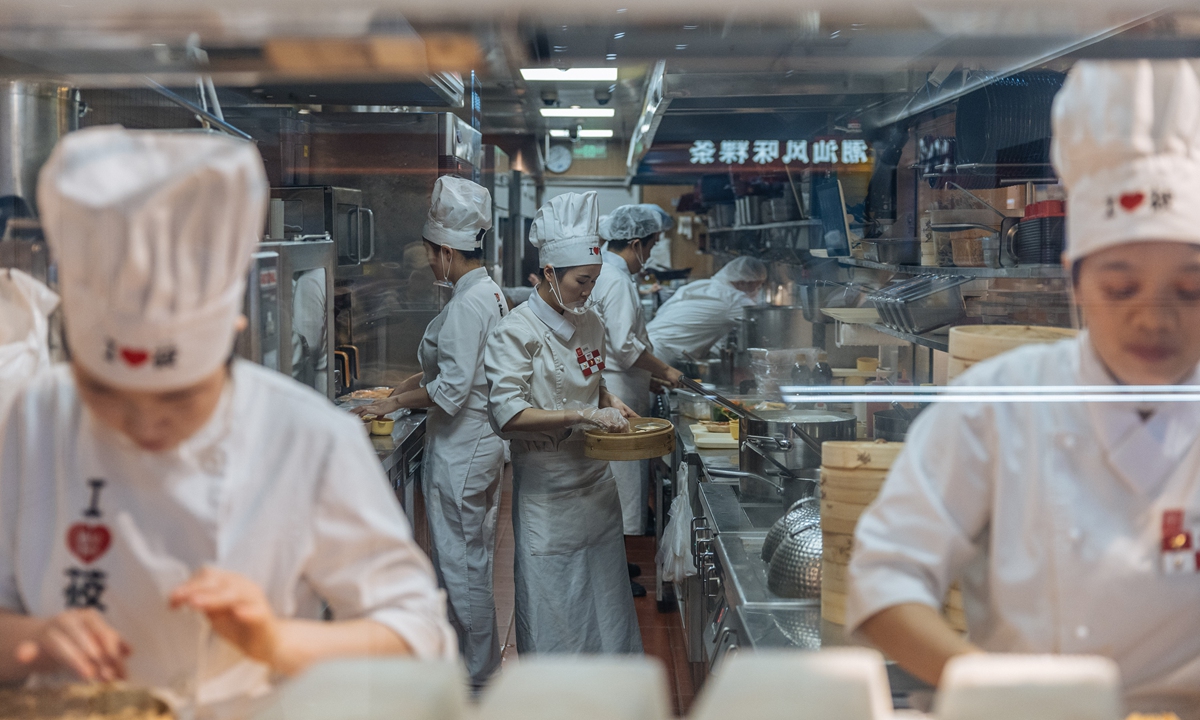Chefs work at a Xibei restaurant in Beijing amid the controversy over 