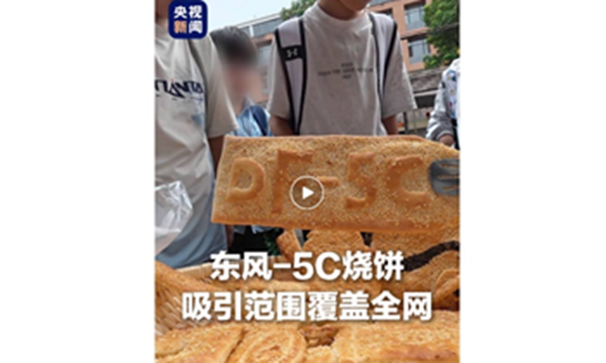 A young man sells DF-5C missile-shaped flatbreads in Zhengzhou, Central China's Henan Province. Photo: Screenshot from CCTV News