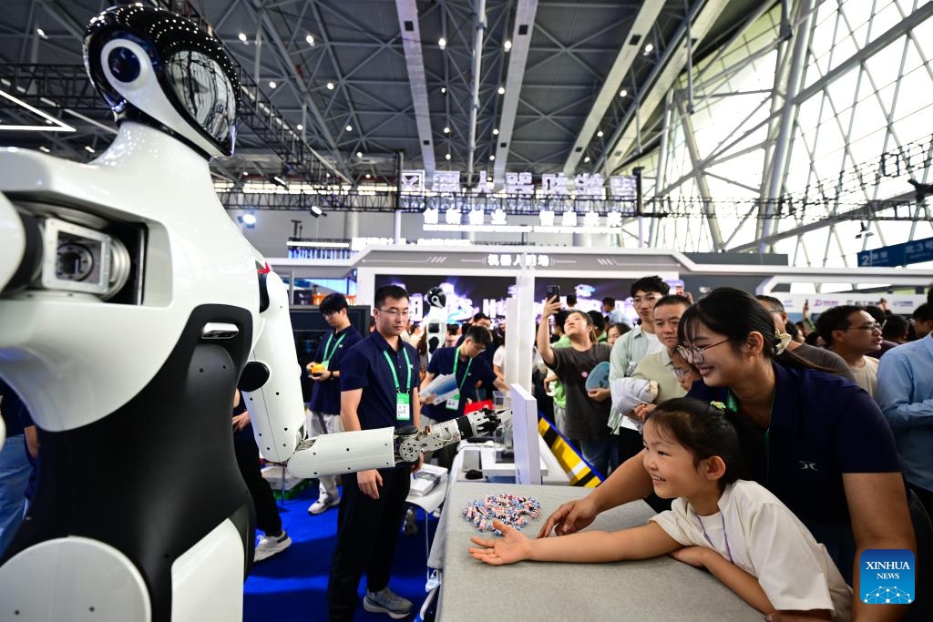 A child interacts with a robot displayed at the 2025 World Manufacturing Convention (WMC) in Hefei, east China's Anhui Province, Sept. 20, 2025. Themed Intelligent Manufacturing For a Better Future, the 2025 WMC kicked off here on Saturday. (Photo: Xinhua)