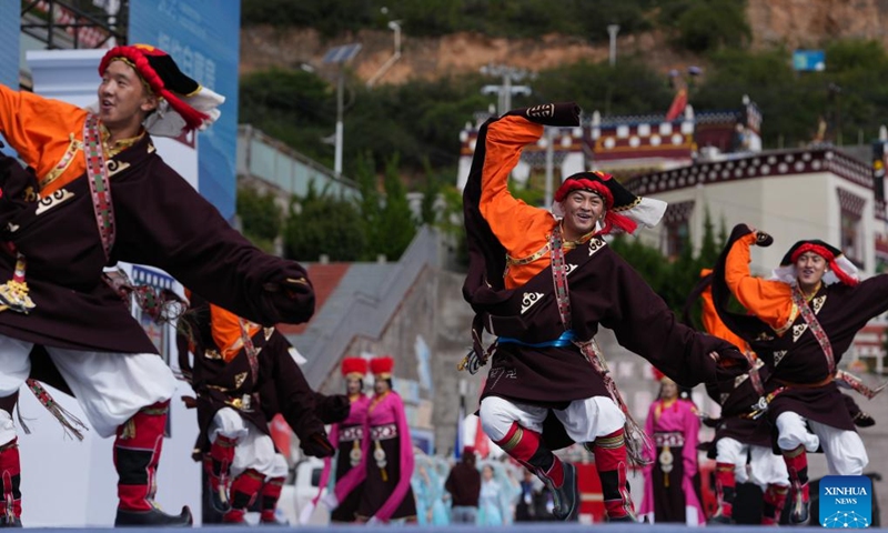 People enjoy Guozhuang dance, a traditional Tibetan square dance, during the opening ceremony of a whitewashing cultural week in Xiangcheng County, Ganzi Tibetan Autonomous Prefecture, southwest China's Sichuan Province, Sept. 20, 2025. A whitewashing cultural week started here on Saturday. Xiangcheng's whitewashed Tibetan houses preserve the core architectural style of the Kamba region. Each year, locals whitewash the exterior walls in a tradition known as the whitewashing ritual. (Photo: Xinhua)