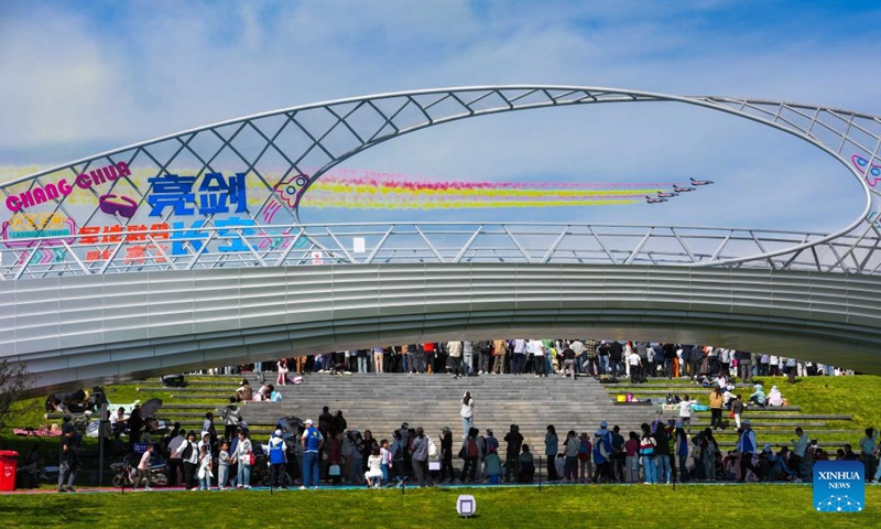 Visitors enjoy an aerobatic performance during the 2025 aviation open-day activities of the Chinese People's Liberation Army (PLA) Air Force and Changchun Air Show in Changchun, northeast China's Jilin Province, Sept. 20, 2025. The event is held here from Sept. 19 to 23, which comprehensively showcases the history and modernization of the PLA Air Force through aerobatic performances, equipment exhibitions, and various interactive activities. (Photo: Xinhua)