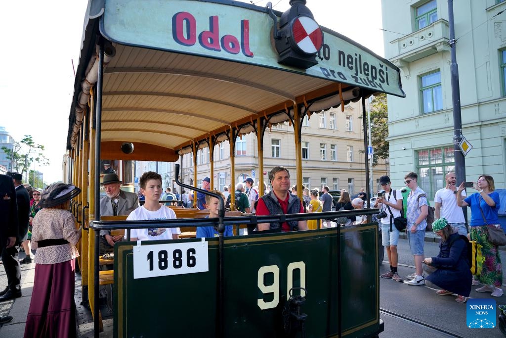 People take a historical tram during a tram parade in Prague, the Czech Republic, on Sept. 21, 2025. A tram parade was held here on Sunday as part of the celebrations to mark 150 years of urban public transport in the Czech capital. (Photo: Xinhua)