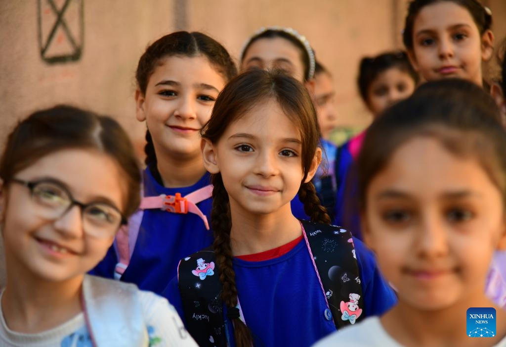 Students pose for a photo on the first day of new academic year in Damascus, Syria, on Sept. 21, 2025. The new academic year began with about 12,000 schools open on Sunday across the country. (Photo: Xinhua)