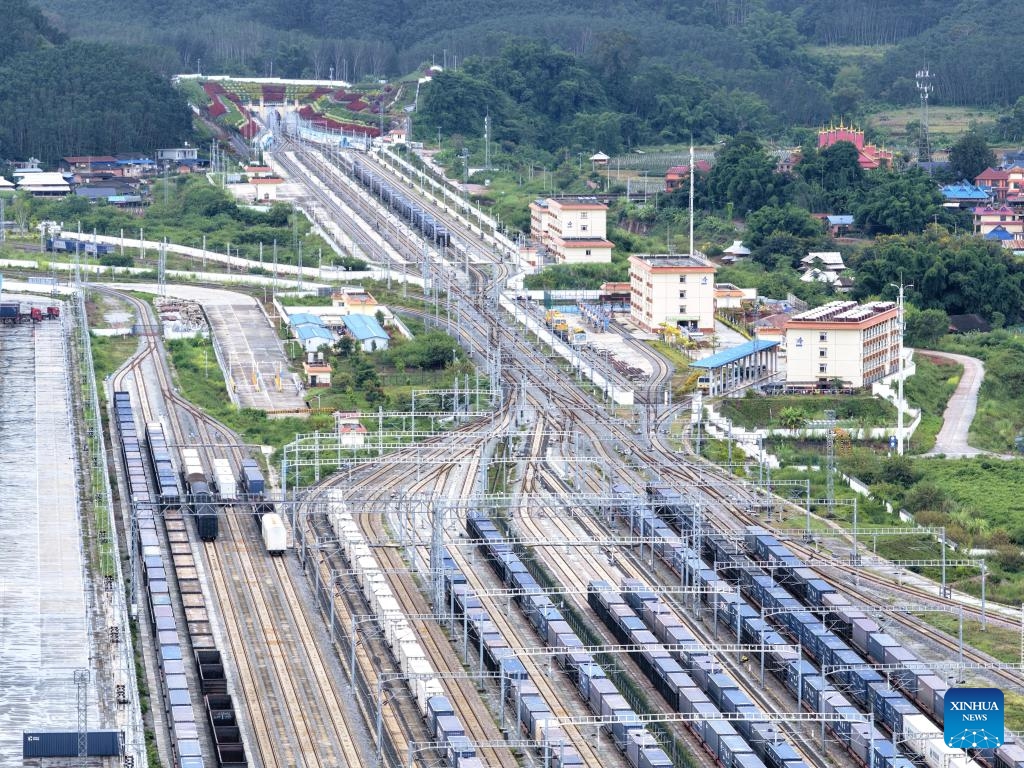 An aerial drone photo taken on Sept. 21, 2025 shows freight trains running past the Mohan Railway Station of the China-Laos Railway in southwest China's Yunnan Province. Since the operation of the China-Laos Railway, the total number of freight trains operational along the line has exceeded 60,000 as of Sept. 19, with a freight volume of over 67.6 million tons, including more than 15 million tons of cross-border trade. (Photo: Xinhua)