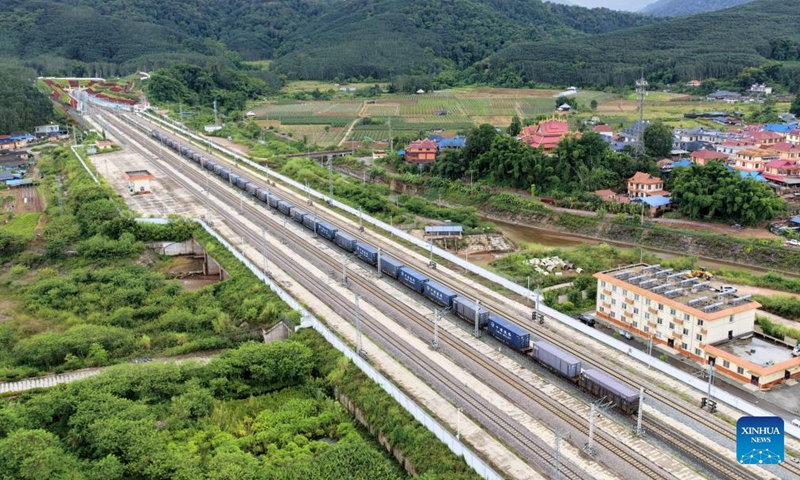 An aerial drone photo taken on Sept. 21, 2025 shows freight trains running past the Mohan Railway Station of the China-Laos Railway in southwest China's Yunnan Province. Since the operation of the China-Laos Railway, the total number of freight trains operational along the line has exceeded 60,000 as of Sept. 19, with a freight volume of over 67.6 million tons, including more than 15 million tons of cross-border trade. (Photo: Xinhua)