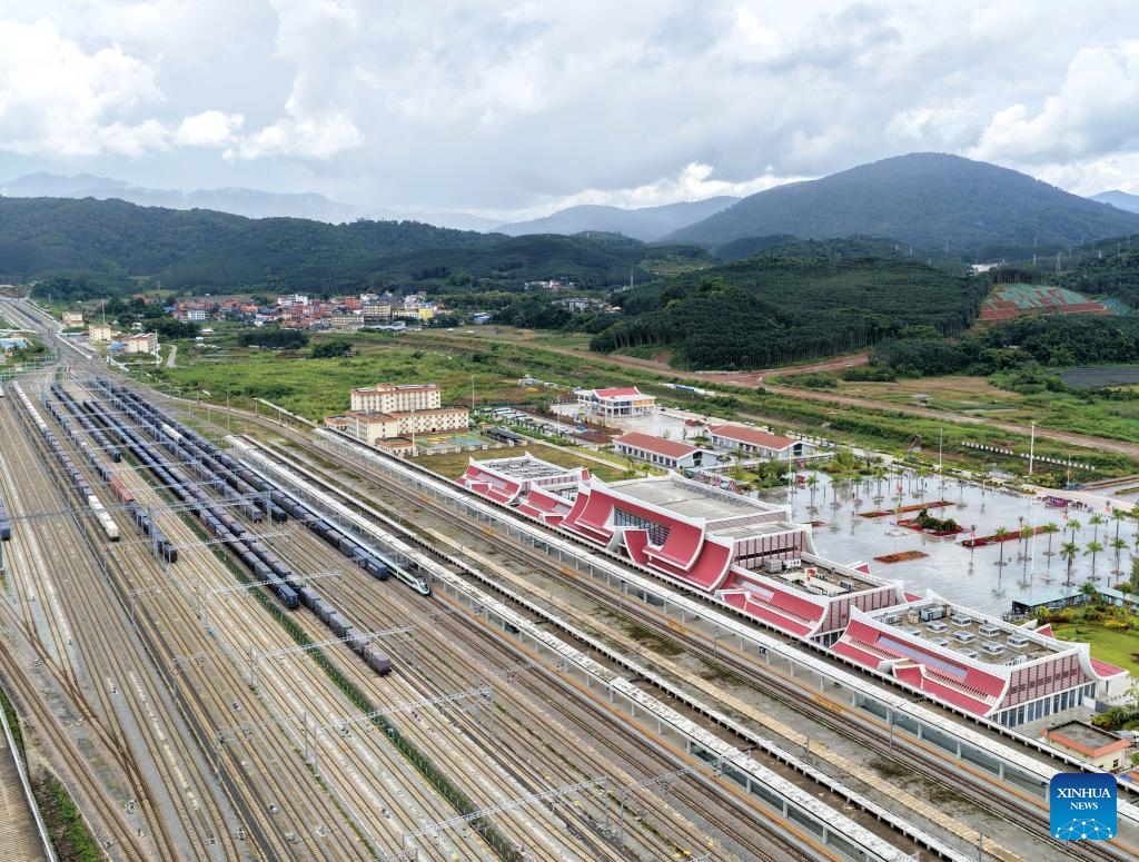 An aerial drone photo taken on Sept. 21, 2025 shows freight trains running past the Mohan Railway Station of the China-Laos Railway in southwest China's Yunnan Province. Since the operation of the China-Laos Railway, the total number of freight trains operational along the line has exceeded 60,000 as of Sept. 19, with a freight volume of over 67.6 million tons, including more than 15 million tons of cross-border trade. (Photo: Xinhua)
