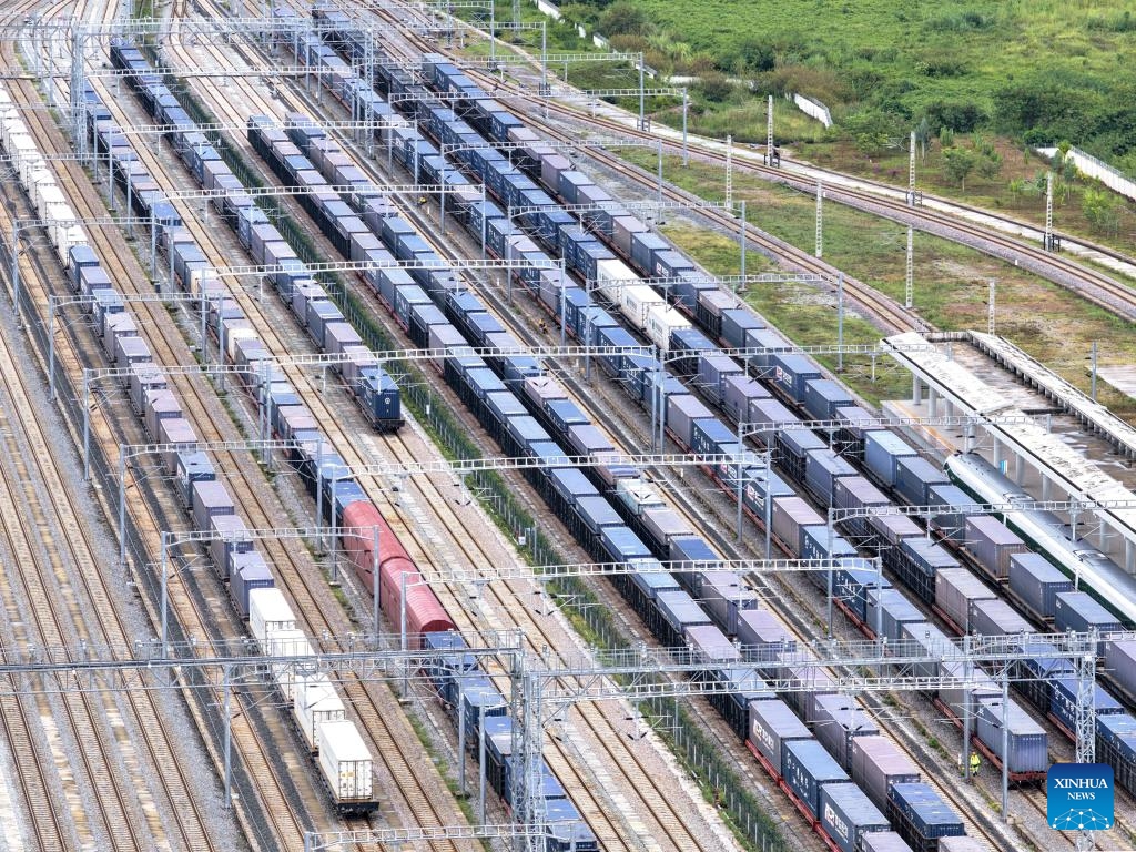 An aerial drone photo taken on Sept. 21, 2025 shows freight trains running past the Mohan Railway Station of the China-Laos Railway in southwest China's Yunnan Province. Since the operation of the China-Laos Railway, the total number of freight trains operational along the line has exceeded 60,000 as of Sept. 19, with a freight volume of over 67.6 million tons, including more than 15 million tons of cross-border trade. (Photo: Xinhua)