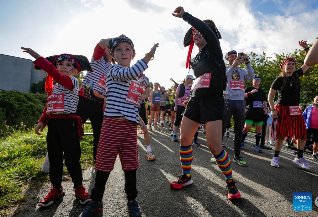 Participants dressed in pirate-themed costumes warm up before the Big Pirate Run in Richmond, British Columbia, Canada, Sept. 21, 2025. The annual fun run featured routes from 1 km to a half marathon and drew hundreds of runners of all ages. (Photo: Xinhua)