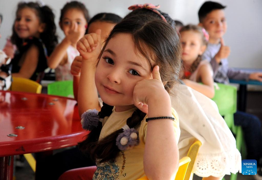 A girl poses for a photo on the first day of new academic year in Damascus, Syria, on Sept. 21, 2025. The new academic year began with about 12,000 schools open on Sunday across the country. (Photo: Xinhua)