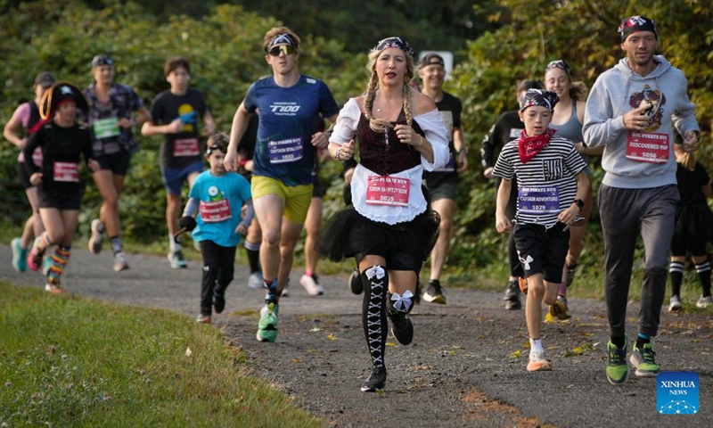 Participants dressed in pirate-themed costumes warm up before the Big Pirate Run in Richmond, British Columbia, Canada, Sept. 21, 2025. The annual fun run featured routes from 1 km to a half marathon and drew hundreds of runners of all ages. (Photo: Xinhua)
