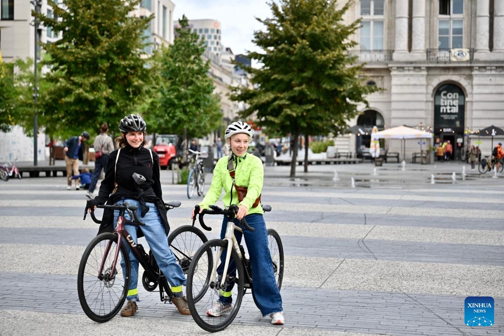 Two young people wait to set off for a group cycling event during Car Free Sunday in Brussels, Belgium, Sept. 21, 2025. Brussels held its annual Car-Free Sunday this weekend, turning most streets of the Belgian capital into car-free zones for the day. From 9:30 a.m. to 7 p.m. local time on Sunday, motor vehicles were banned throughout the Brussels Region, with the exception of public transport, taxis, emergency services, police, and persons with a special permit. (Photo: Xinhua)