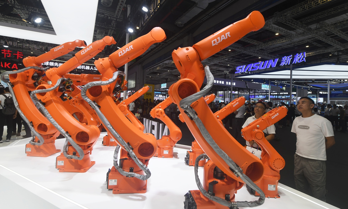 Visitors observe a new robot model at the 25th Session of the China International Industry Fair in Shanghai on September 23, 2025. This year's expo aims to foster an open and collaborative ecosystem for intelligent industries, offering Chinese solutions for global industrial transformation. The event is set to feature the launch of thousands of new products and technologies, making it the largest and most advanced session in its history. Photo: VCG