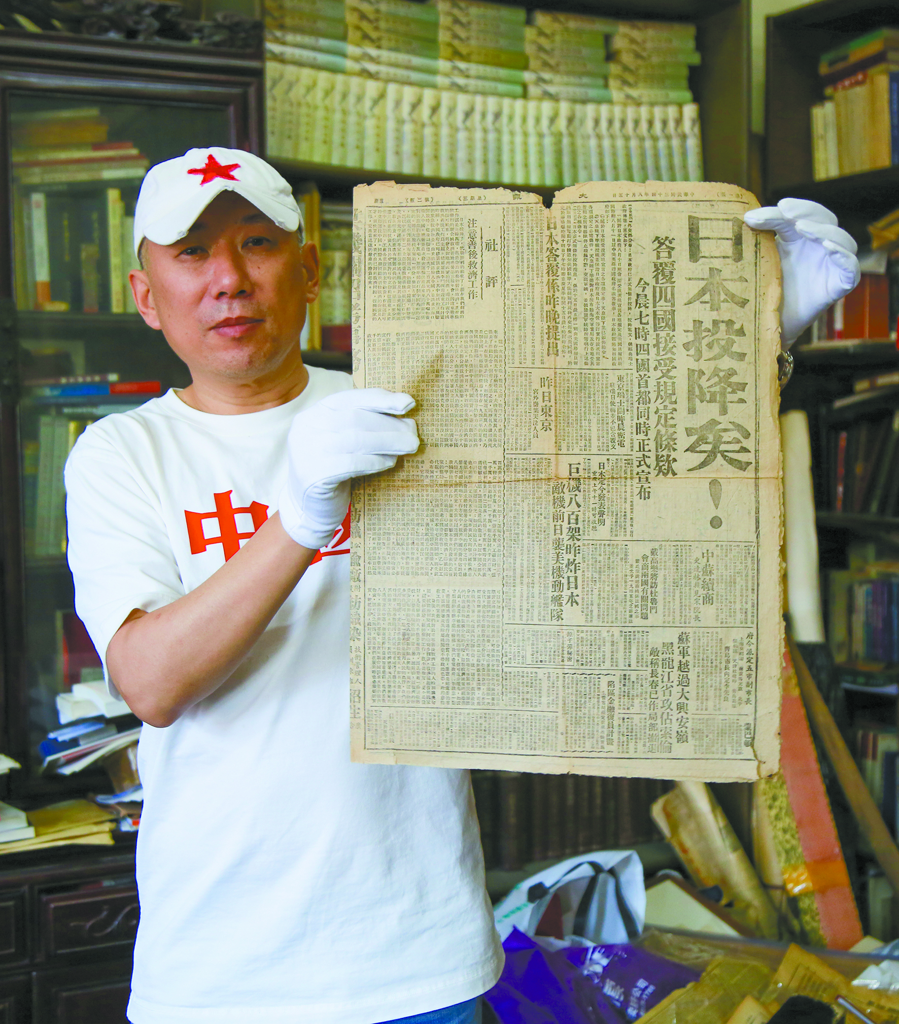 Wu Xianbin displays the original front page of Ta Kung Pao - which proclaims 