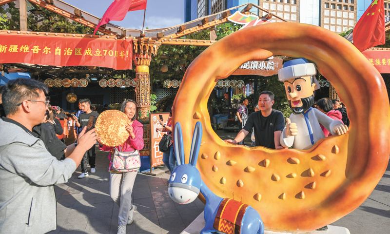 Tourists visit the landmark attraction, the International Grand Bazaar, in Urumqi, capital of Northwest China's Xinjiang Uygur Autonomous Region, on September 23, 2025. Photo: VCG