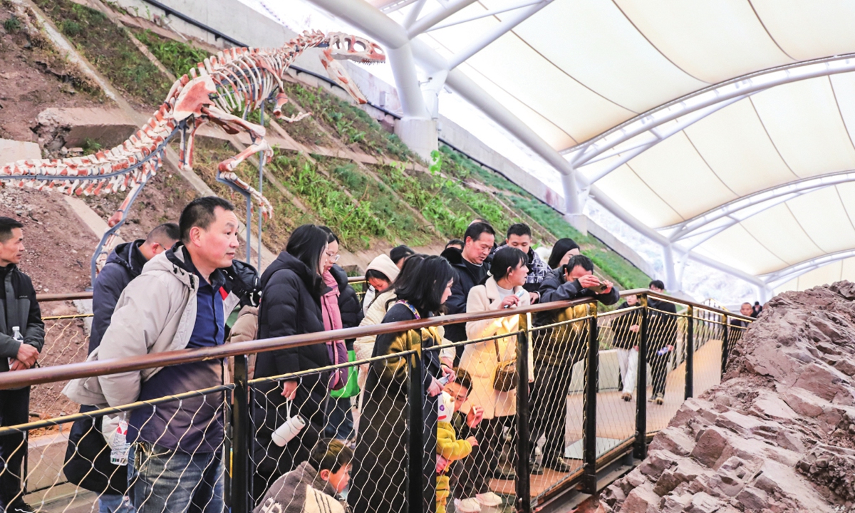 Toursits visit the Dinosaur Fossil Site Museum in Chongqing's Yunyang Global Geopark in September 2025.