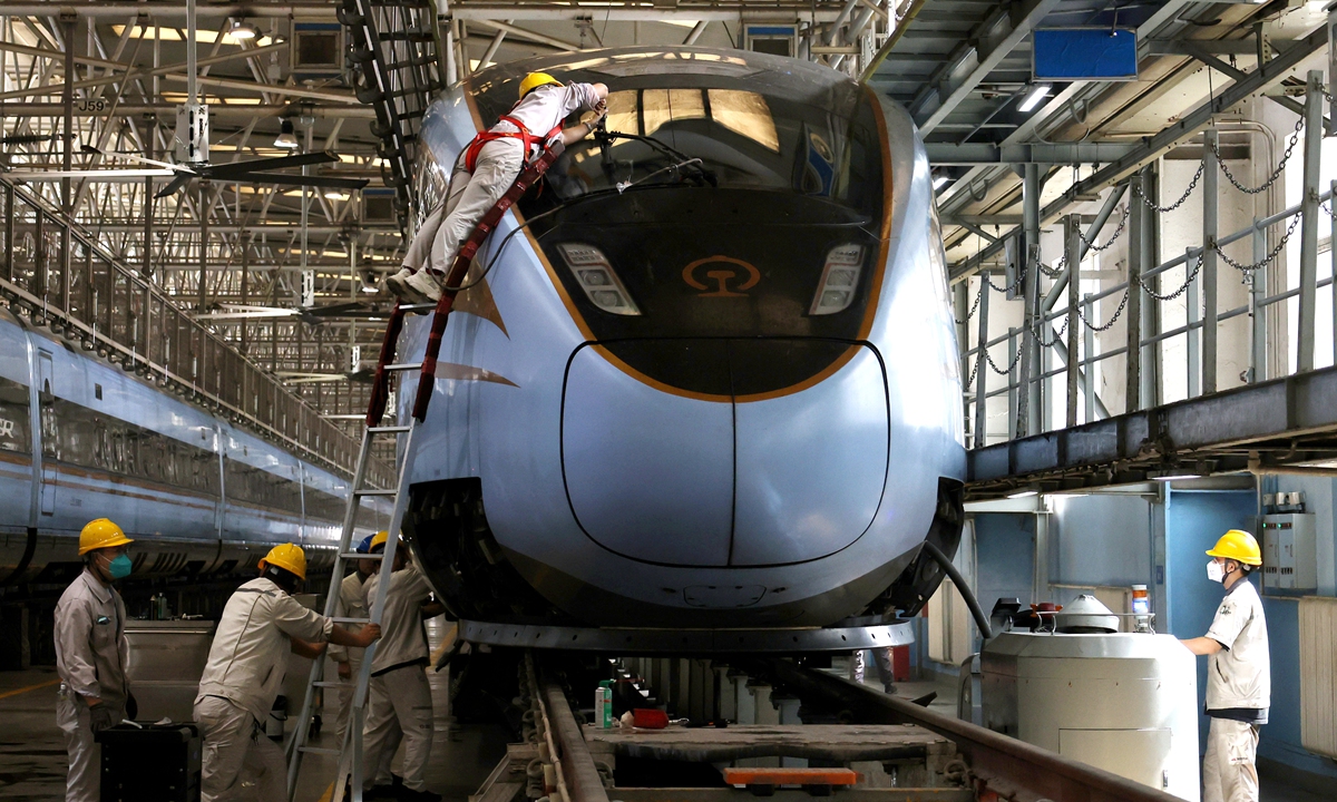 Workers inspect a high-speed train in Xi'an, Northwest China's Shaanxi Province on September 25, 2025. With the National Day holidays approaching, the Xi'an multiple-unit train depot is meticulously inspecting the trains and implementing security measures to guarantee passenger transport during the holiday period. Photo:VCG