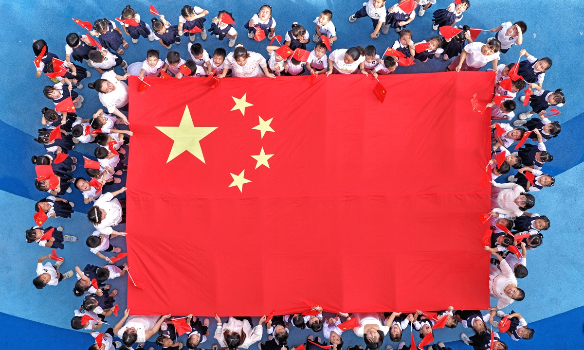 Children from Xianju Town in Taizhou, East China's Zhejiang Province, take a photo around the Chinese national flag and express their blessings for the motherland on September 25, 2025, ahead of China's National Day, which is on October 1. Photo: VCG