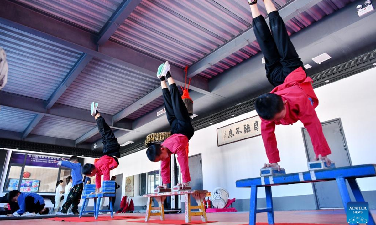 Students practice acrobatic skills at Zhang Shuo's acrobatic courtyard in Sangyuan Town, Wuqiao County, north China's Hebei Province, on Sept. 25, 2025. Wuqiao, dubbed the cradle of Chinese acrobatic art, boasts 14 diverse acrobatic courtyards that serve as a cluster of bases for artist training, new play designing, and folk art research. (Xinhua/Mu Yu)