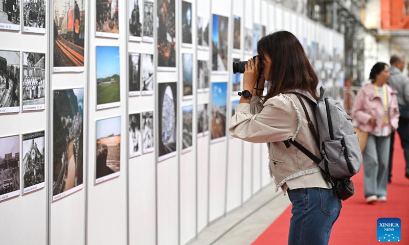 A visitor takes a photo at a railway photo exhibition during an expo themed on Chinese railway culture in Beijing, capital of China, Sept. 27, 2025. An expo displaying collections of items on Chinese railway culture kicked off here on Saturday, showcasing the development and achievement of Chinese railway. (Photo: Xinhua)
