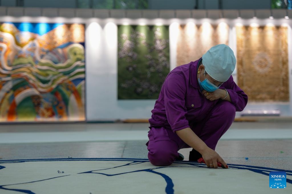 An employee works on a Tibetan carpet at a workshop of Shengyuan carpet group in Xining, northwest China's Qinghai Province, Sept. 27, 2025. Tibetan carpet is a traditional handicraft on the Qinghai-Tibetan Plateau with a history of more than 1,000 years. The carpets are essential items for the nomadic people on the plateau to withstand the cold. The fine yak and sheep wool and the delicate weaving skills and patterns made the handmade products popular among overseas and domestic customers. (Photo: Xinhua)