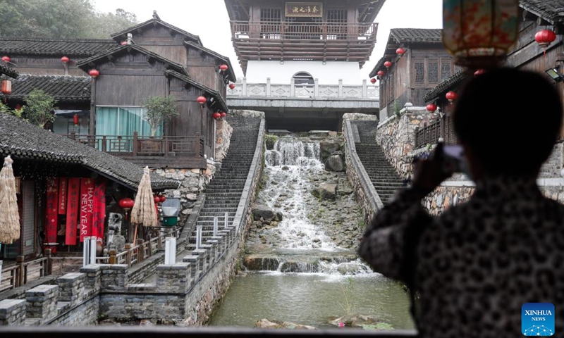 A visitor takes a photo of an ancient village at Baohua Mountain National Park in Jurong, east China's Jiangsu Province, Sept. 27, 2025. Baohua Mountain National Park has attracted a lot of tourists recently for its beautiful autumn scenery as well as its cultural and historical view. (Photo: Xinhua)