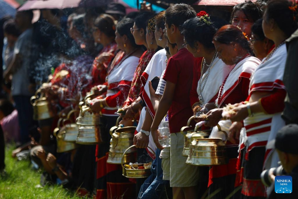 People in traditional attire wait to make offerings to masked dancers during an event in celebration of the Sikali Jatra festival in Lalitpur, Nepal, Sept. 27, 2025. The festival, also called the festival of Rudrayani, is celebrated here on Saturday. (Photo: Xinhua)