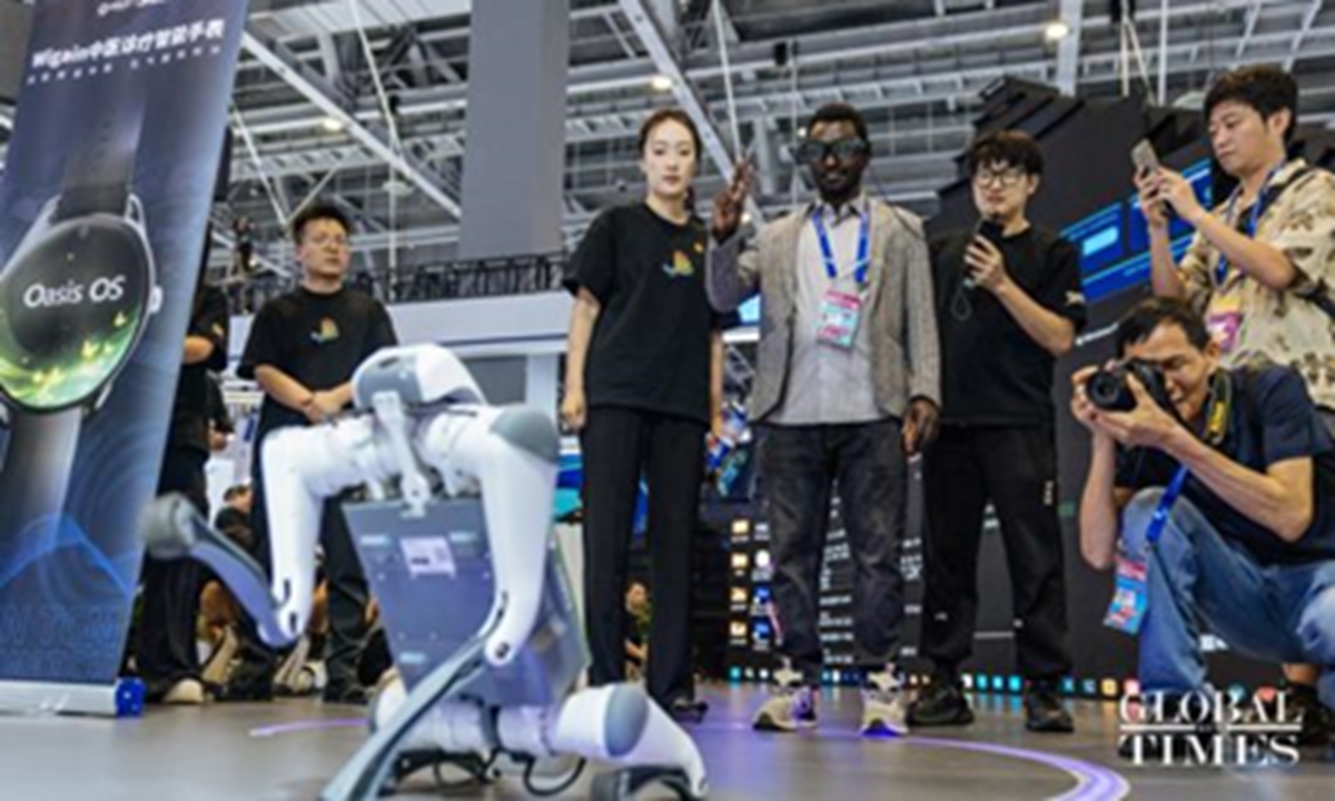 Participants to the 4th Global Digital Trade Expo watch a robotic dog on September 25, 2025, in Hangzhou, East China's Zhejiang Province. The expo, held from September 25-29, includes a main pavilion named 