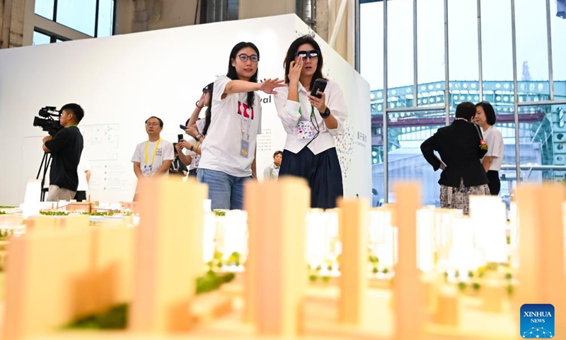 People visit an exhibition of Shanghai Urban Space Art Season 2025 in Shanghai, east China, on Sept. 30, 2025. Sci-tech design exhibition, art show, drone performance and light show are scheduled to be held during the event. (Xinhua/Chen Haoming)