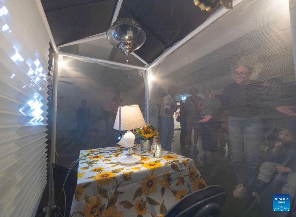 People view the art installation Home, Sweet Home during the 2025 Nuit Blanche event in Toronto, Canada, on Oct. 4, 2025. The annual all-night art festival kicked off here on Saturday, showcasing more than 85 contemporary artworks by local, national and international artists in public spaces. (Photo by Zou Zheng/Xinhua)