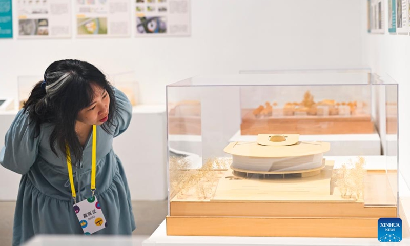 A woman visits an exhibition of Shanghai Urban Space Art Season 2025 in Shanghai, east China, on Sept. 30, 2025. Sci-tech design exhibition, art show, drone performance and light show are scheduled to be held during the event. (Xinhua/Chen Haoming)