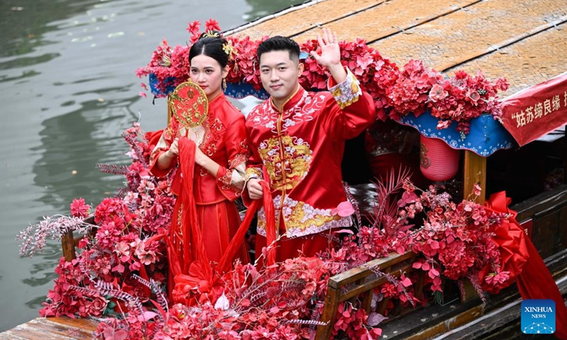 A couple takes a boat tour during a group wedding in the Luzhi ancient town in Suzhou, east China's Jiangsu Province, Sept. 29, 2025. Photo: Xinhua