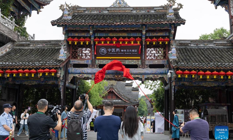 People visit the Traditional Chinese Medicine (TCM) Street in Bishan District, southwest China's Chongqing Municipality, Sept. 30, 2025. The Traditional Chinese Medicine Street, a cultural block featuring traditional Chinese medicine, opened to public on Tuesday. Characteristic cultural fairs, free TCM clinics, and Qigong performances will be held here during the upcoming National Day holiday and the Mid-Autumn Festival. (Xinhua/Chen Cheng)