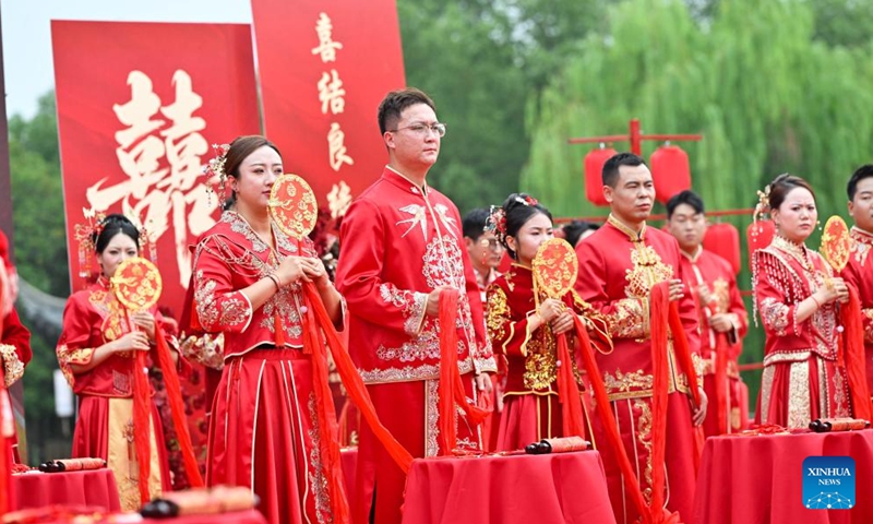 A couple takes a boat tour during a group wedding in the Luzhi ancient town in Suzhou, east China's Jiangsu Province, Sept. 29, 2025. Photo: Xinhua