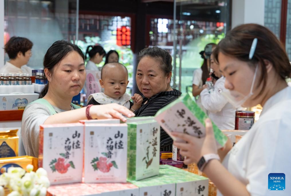 People select products at the Traditional Chinese Medicine (TCM) Street in Bishan District, southwest China's Chongqing Municipality, Sept. 30, 2025. The Traditional Chinese Medicine Street, a cultural block featuring traditional Chinese medicine, opened to public on Tuesday. Characteristic cultural fairs, free TCM clinics, and Qigong performances will be held here during the upcoming National Day holiday and the Mid-Autumn Festival. (Xinhua/Chen Cheng)